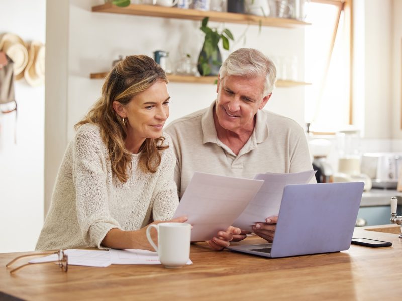 retirement-finance-and-couple-with-budget-on-laptop-satisfied-with-home-expenses-in-new-zealand-h.jpg